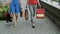 Legs slender young women walking down the street past the store with shopping bags, slow mo stedicam shot