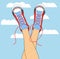 Legs in sneakers on the background of the sky with clouds.