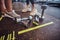 Legs in sneakers close-up next to a dumbbells. Two female friends talking, having a break, trains in the modern gym.