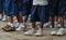 Legs with sneakers and school uniform pants of African pre school children, Matadi, Congo, Central Africa