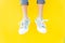 Legs sneakers on yellow background, lifestyle fashion