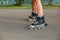 Legs of sports girls on a roller skate walk
