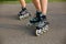Legs of sports girls on a roller skate walk