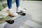 Legs of teenage urban girl on skateboard at skate park on the evening.