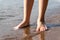 legs teenager on the sandy beach close-up. summer holiday