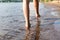 legs teenager on the sandy beach close-up. summer holiday