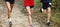 Legs of three runners on a dirt path running toward camera