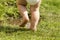 Legs of a toddler with diaper-Messy child feets on the grass