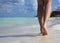 Legs on Tropical Sand Beach with footprints