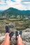 Legs of two hikers who sitting on a cliffs edge