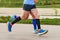 legs two male runners in compression socks and sleeves run marathon