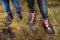 Legs of two tourists in rubber boots and marshes, top view