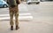 Legs of Ukrainian soldier in military uniform. man in military uniform on city street.