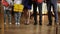 Legs of unrecognizable happy family of five people standing with Christmas gifts on New Year day at home in living room