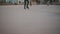 Legs of unrecognizable people ride on a city open ice rink in the evening. Winter skating public rink on Christmas Fair