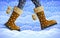 Legs of walking person over winter background, season specifics