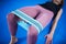 Legs woman barefoot doing pilates exercise with elastic fabric resistance band. Resistance Bands for butt and Legs, Exercise bands