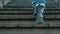 Legs woman climb wooden stairs in blue jeans and black boots