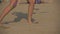 Legs of a woman and her body shadow playing volleyball on a beach