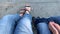 Legs of a woman and her son sitting on a bench in summer or autumn city park an relaxing, family leisure and recreation