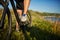 Legs of a woman in sneakers with a bicycle close up