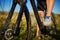 Legs of a woman in sneakers with a bicycle close up