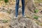 Legs of woman standing on mound of dirt