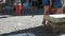 Legs of a woman while she is taking photos of three young girls