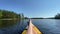 legs of woman on yellow kayak bow sailing along river water