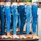 Legs of women mannequins dressed in various jeans in a market outdoors