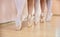 Legs of young ballerinas standing on pointe in row