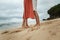 Legs of a young beautiful couple on a sandy beach of Indonesia