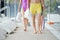 Legs of young couple and their little daughter in swimwear moving forwards