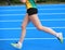 Legs of young female athlete runs in athletics track