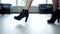 Legs of a young female office worker in high heels walks along the office corridor. Business concept, business lady