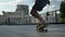 Legs of young man skateboarder doing skateboard trick in daytime in summer, sport concept, urban concept, back view