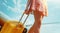 Legs of young woman with suitcase