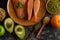 Legumes, fruit and salmon pieces on a wooden plate