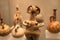 Leiden, The Netherlands - JAN 04, 2020: closeup of a terracotta figurine from ancient Cyprus with old vases on the background.