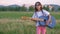 Leisure activity happy hippie retro little girl in sunglasses playing denim acoustic guitar on summer outdoor green field