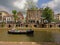 Leisure boat on `oudegracht` canal in Utrecht, with typical dutch houses, with cellars coming out on an old wharf