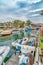 Leisure boats on public canal lined with elegant houses in Long Beach California
