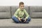 Leisure, children, technology and people concept - smiling boy with joystick playing video game at home