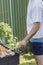 leisure, food, people and holidays concept - happy young man cooking meat on barbecue grill at outdoor summer party