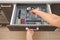 Leisure, lifestyle, domestic life concept. Photo from first person pov view woman hand open new brown kitchen drawer by modern do