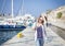 Leisure woman walking on holiday in yacht and sailboats marina r