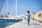 Leisure woman walking on holiday in yacht and sailboats marina r