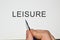 Leisure word written on white paper