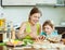 Leisurely makes dumplings with red fish in a home kitchen