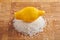 Lemon above pile of coarse sea salt on cutting board